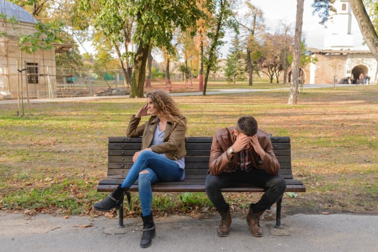 picture of distressed couple on park bench